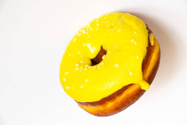 istock donut in yellow glaze on an isolated background 1500484743