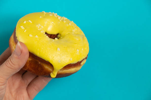 istock donut in yellow glaze on an isolated background 1500484784