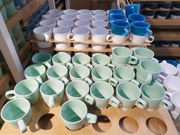 istock cups in warehouse, shop. different color cups a lot 1500485412