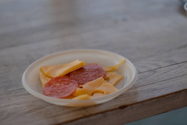 istock slicing cheese and sausages in a plastic plate on the table 1500487003