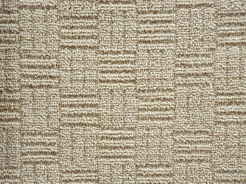 Beige carpet texture background, square shape pattern. Polypropylene carpet, close-up, top view, texture, braided rough beige rug