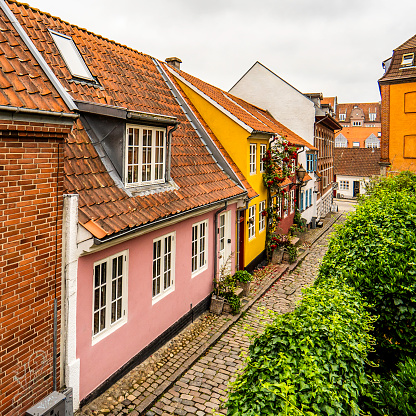 Angled view of small, colorful houses on Roldgade in Aalborg, square, 1:1