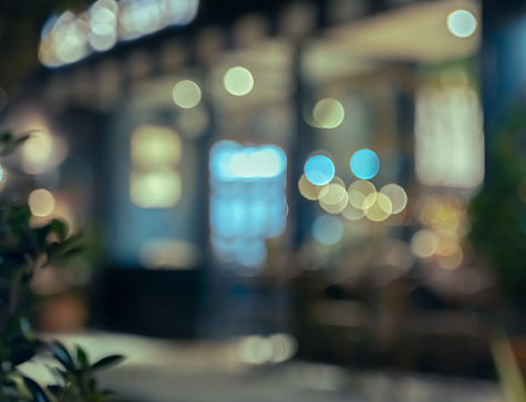 Defocused image of shop or cafe  with bokeh coloful night lights background