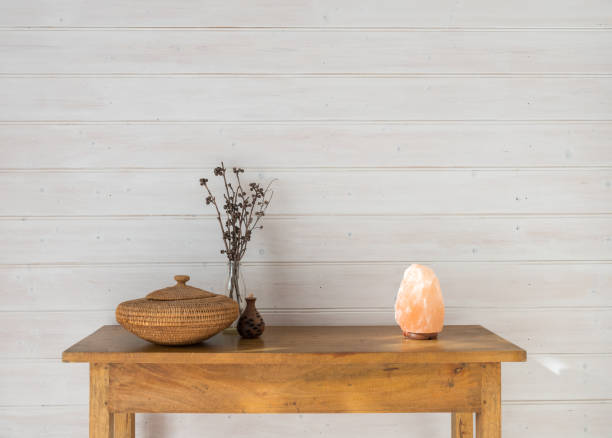 istock Oak side table with rustic accessories against white painted wood panelled wall 1500490309