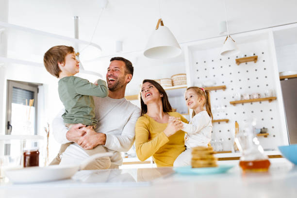 istock Cheerful parents having fun with their kids at home. 1500490457