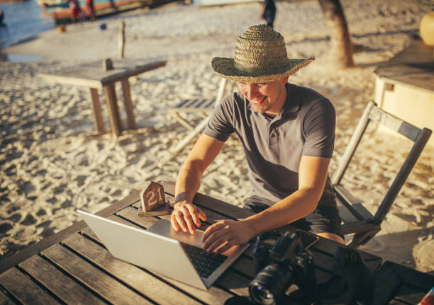 A freelance man works online in a cafe on the beach