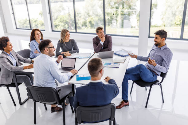 istock Happy business team talking on a meeting in the office. 1500490549