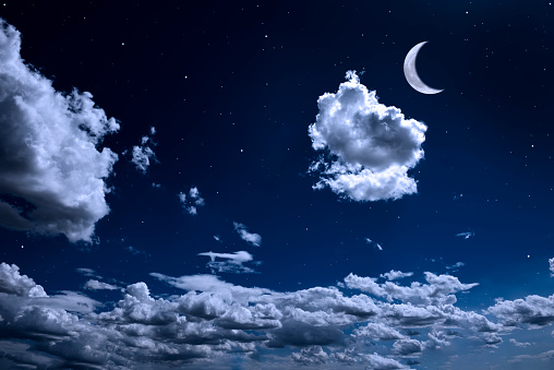 Crescent moon rising over the cloudscape with copy space.