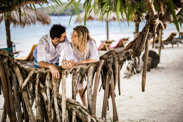istock Young happy couple talking during summer day on the beach. 1500491857