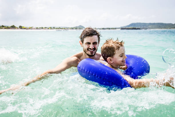 istock Carefree father and son having fun in sea. 1500492676