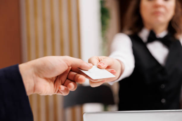 istock Hotel worker gives access card to guest 1500493825