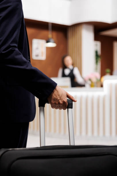 istock Hotel guest enter reception with luggage 1500493926
