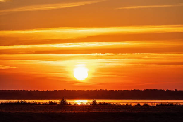 istock Scenic view at a sunset by a lake with the sun 1500495650