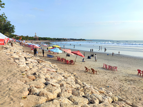 People enjoying at the famous Kuta beach, Bali, Indonesia