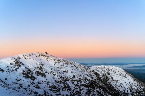 istock mountains covered with snow with clouds underneath a full sky, at sunset 1500502006