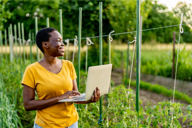 istock Successful farmer standing in the garden with laptop. 1500502124