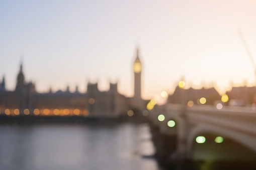 abstract blurred sunset skyline hour at Bigben tower in house of parliament with Thames river and bridge landmarks in London city  spot photography for travel background design concept