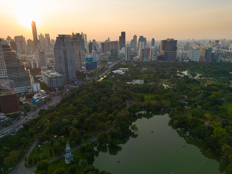 Lumpini park with office building in Bangkok city central of Thailand aerial view