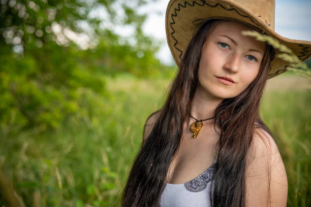 a woman with cowboy hat in nature