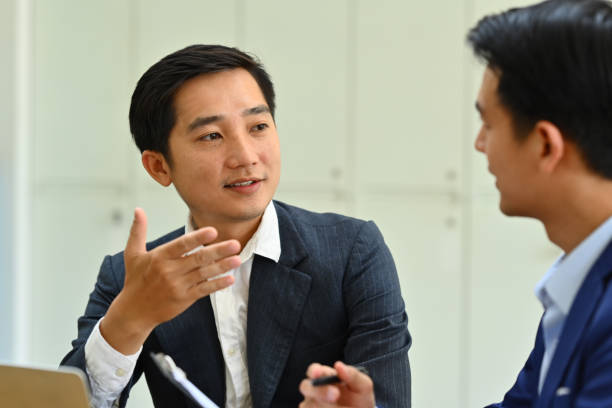 istock Confident male team leader explaining project details, talking about company strategy and business plan during meeting. 1500513174