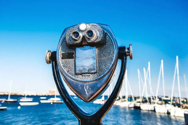Coin-operated tourist binoculars in USA in front sea and ocean Skyline