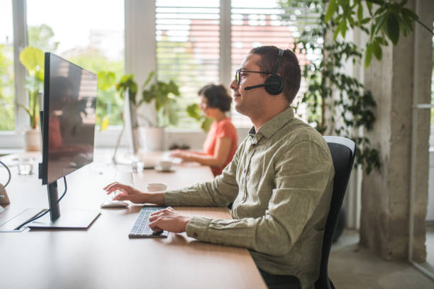 istock Smiling Hispanic Male Employee Engaged in Call Center Operations 1500517586