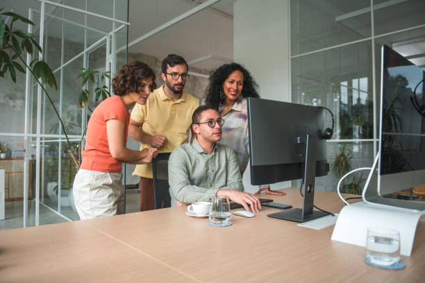 istock Diverse Team Stands Behind Hispanic Male Call Center Employee for Client Acquisition 1500517634