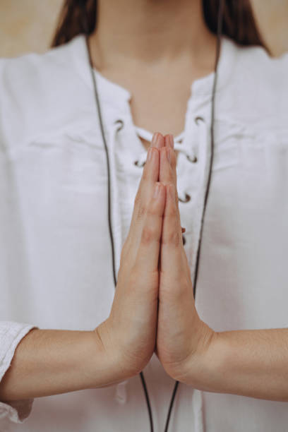 istock Woman with praying hands practicing yoga 1500517714
