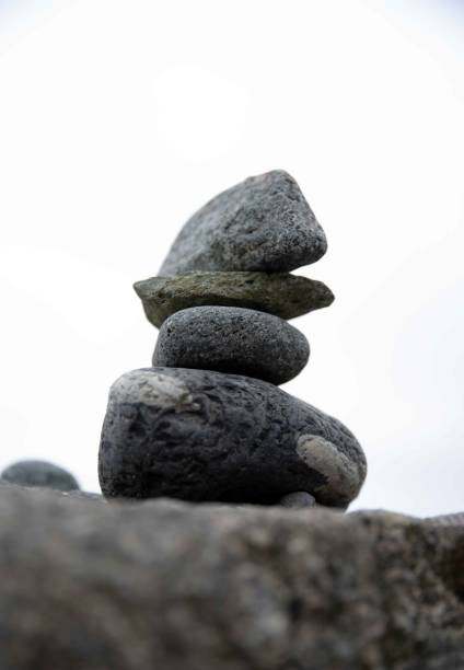 istock Stacked cairn stone zen sculpture on New England beach 1500518823