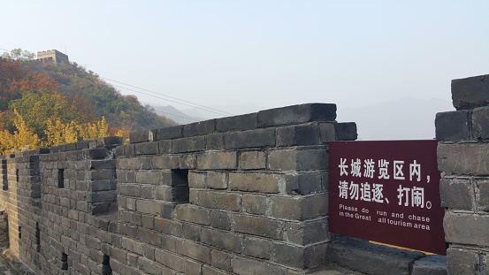 The Great Wall of China snakes across lush hills. This section is between Jinshanling and Simatai.