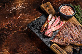 Barbecue dry aged wagyu entrecote rib eye beef steak. Dark background. Top view. Copy space