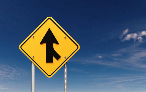 istock Merging Lanes Yellow Traffic Sign Before Blue Sky 1500527242