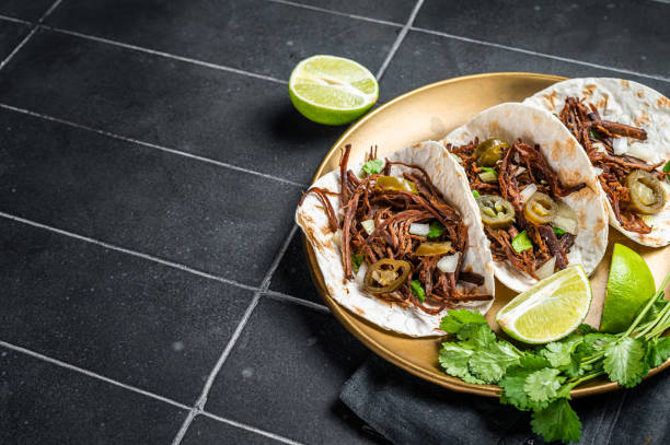 istock Mexican Beef Barbacoa Tacos with Cilantro and Onion. Black background. Top view. Copy space 1500530060
