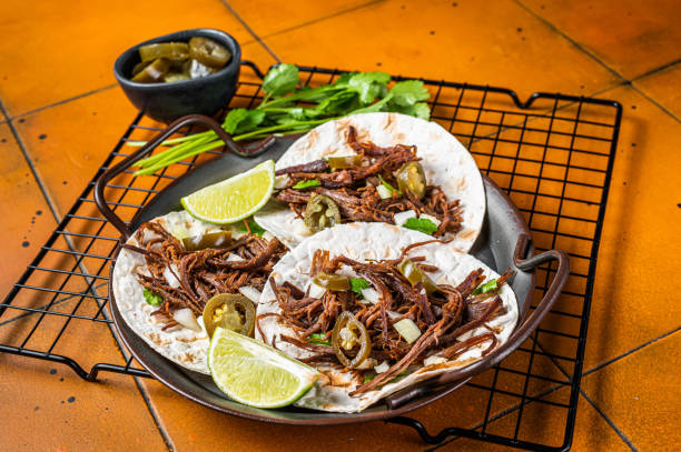 istock Spicy Beef Barbacoa Tacos with Cilantro and Onion. Orange background. Top view 1500530977