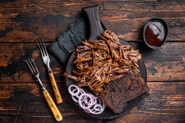 istock Traditional barbecue wagyu pulled beef on wooden board. Wooden background. Top view 1500531348