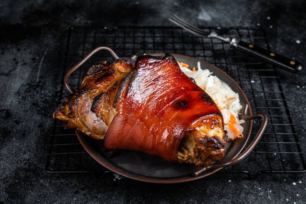 traditional german cuisine roasted pork knuckle schweinshaxe with sauerkraut. black background. top view - shank sauerkraut german cuisine pork imagens e fotografias de stock