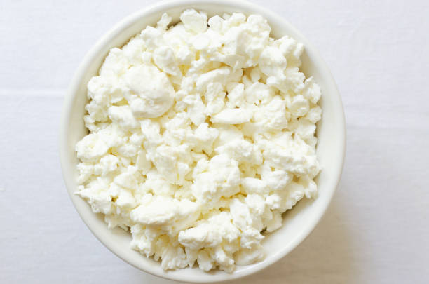 istock Organic cottage cheese in a white ceramic bowl on a white tablecloth. Healthy breakfast. Concept of healthy food. Selective focus. Horizontal orientation. Top view. Cpy space. 1500537203