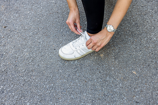 White sneakers are hanging on a clothesline