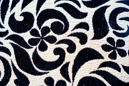 A close-up picture shows a beautiful pattern on a black and white pillowcase made of fine cotton.