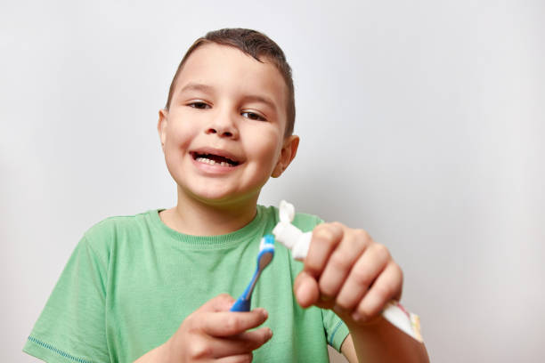 istock A boy with missing baby teeth uses a toothbrush. Baby teeth care. 1500539136
