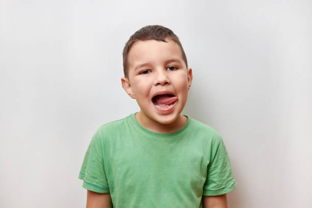 istock A handsome, cheerful guy poses emotionally for the camera, showing his tongue. 1500539307