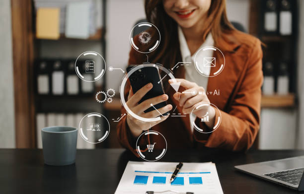 istock Woman working with laptop computer and smart phone on desk in modern office with virtual icon diagram 1500542080