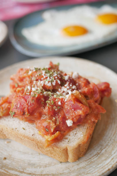 istock morning breakfast with tomato Scrambled eggs on a bread on white plate 1500547652