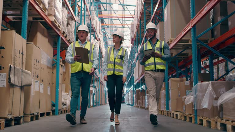 Factory teamwork, tablet or people checking inventory package, export cargo product or logistics plant. Warehouse conversation, box shipping collaboration or team review stock take checklist