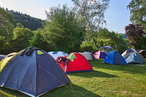 colorful tents on a green meadow in the evening