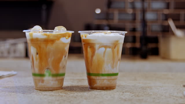 https://media.istockphoto.com/id/1500554392/video/cold-brew-plastic-and-cup-with-coffee-ice-and-milk-on-counter-with-barista-quality-drinks-at.jpg?s=640x640&k=20&c=78kQHYN0pY1plrVf3IuidvgAPDIEW7NyEVOxdciY9RE=