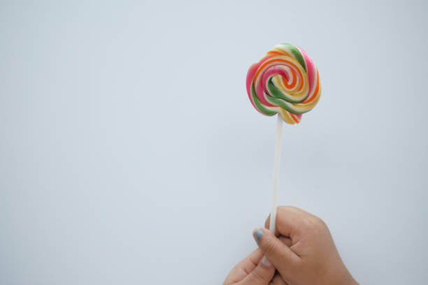 istock child holding a lollipop candy 1500556697