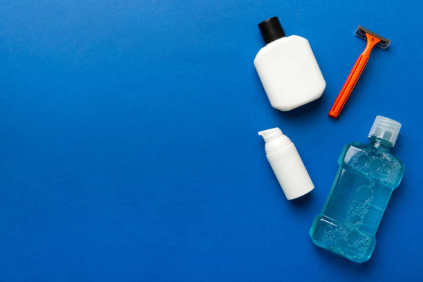 istock Composition with bath cosmetics on table. razor, toothpaste, soap, gel, toothbrush, mouthwash and other various accessories. Cosmetics for skin health. Bath Mockup for your logo 1500560525