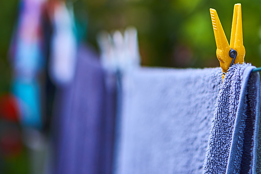 blue towels on clothesline and yellow clip