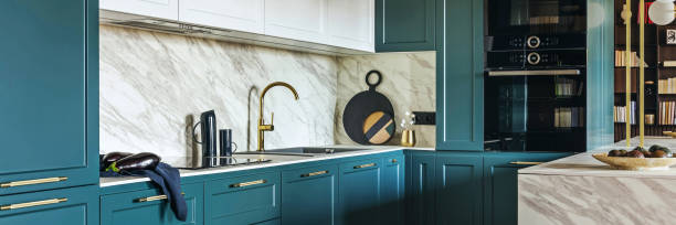 istock Luxury modern and vintage turquoise and white kitchen. Marble kitchen island with white owal chandelier . Gold tap on marble table top. Template. 1500566115